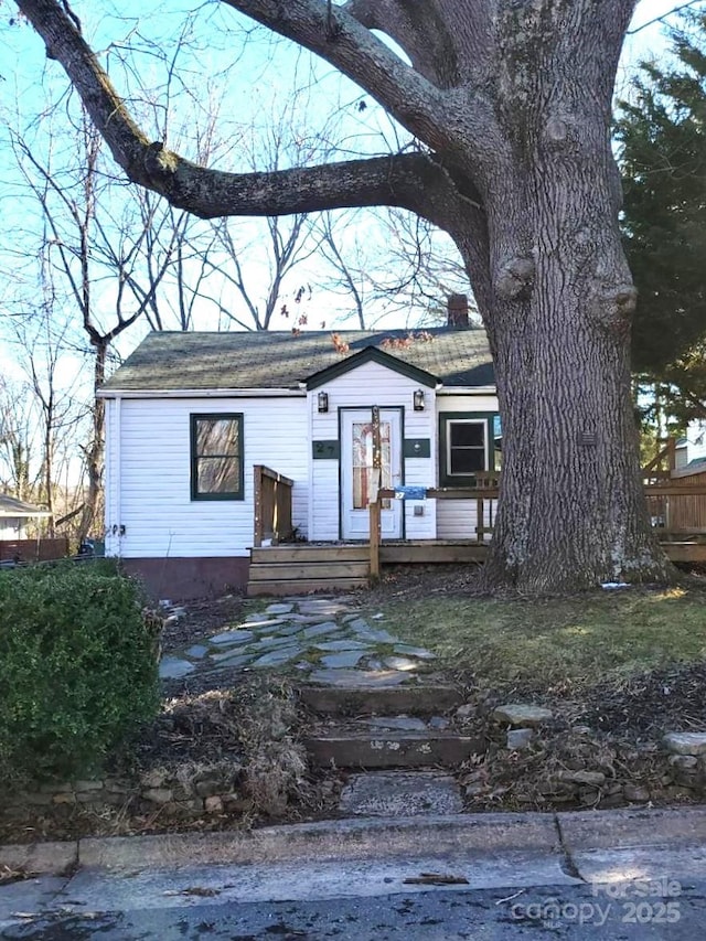 view of front of house featuring a deck and a chimney