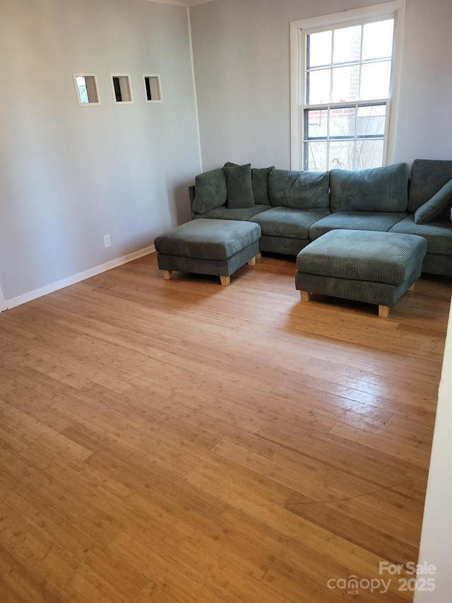 living room with light wood-type flooring and baseboards