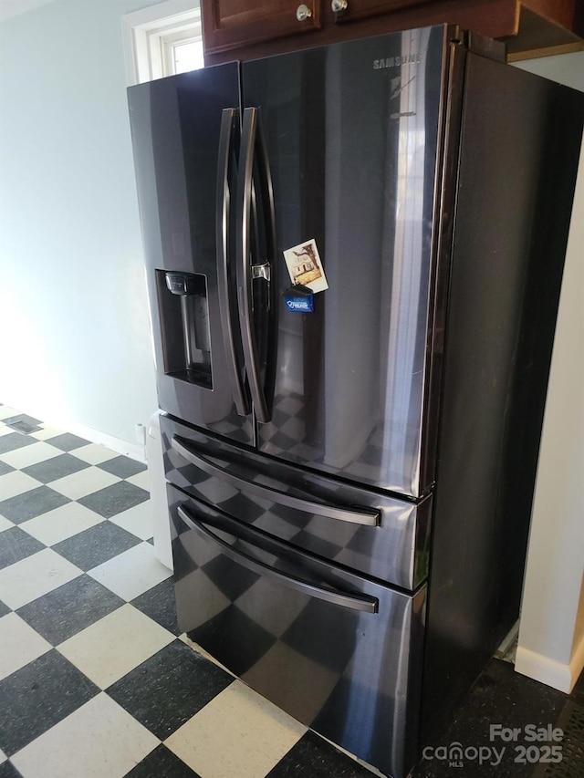 details with dark floors, refrigerator with ice dispenser, and baseboards