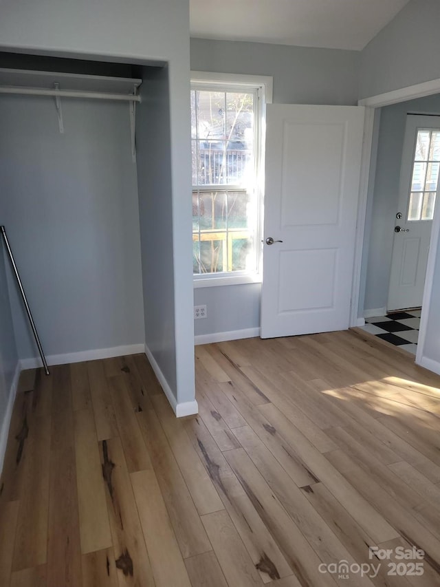 unfurnished bedroom with baseboards and wood finished floors