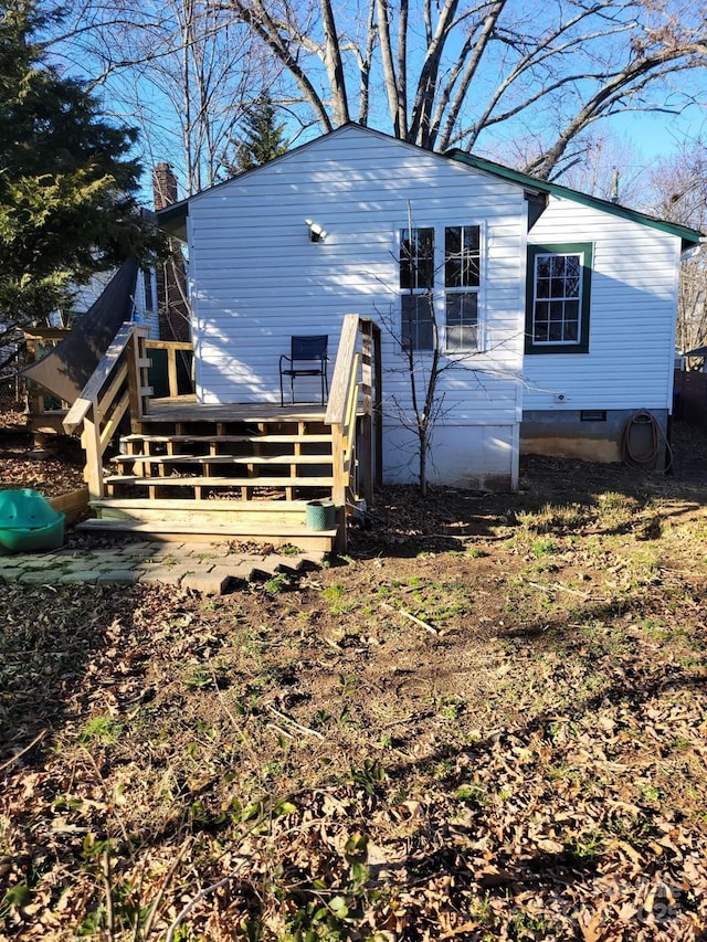 exterior space with crawl space and a wooden deck