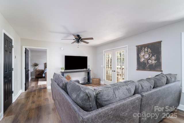 living room featuring dark wood-style floors, french doors, baseboards, and a ceiling fan