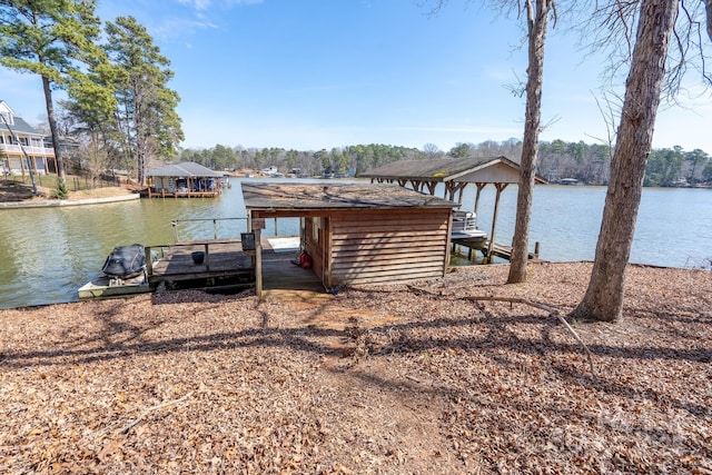 dock area with a water view and boat lift