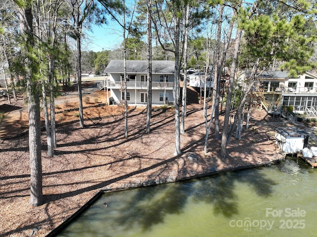 dock area featuring stairway and a water view