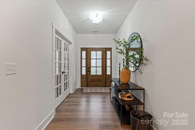 doorway to outside featuring visible vents, french doors, baseboards, and dark wood-style flooring