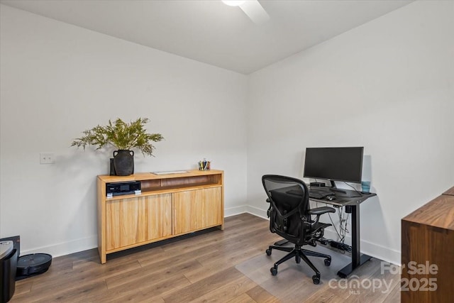 office featuring baseboards and wood finished floors