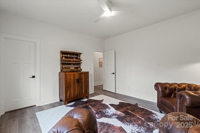 bedroom with ceiling fan, baseboards, and dark wood-style flooring