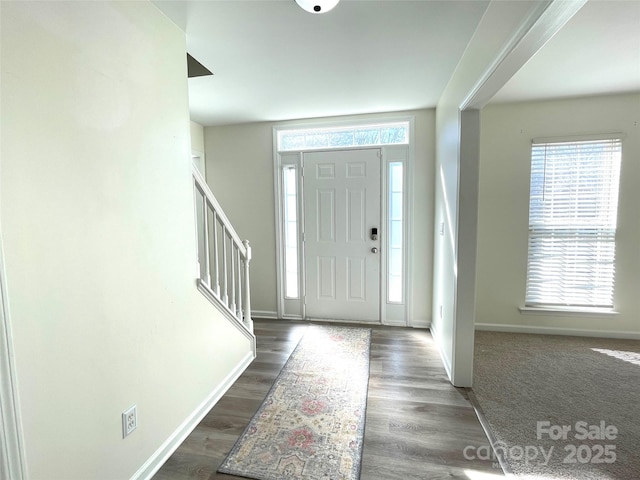 entryway featuring stairway, wood finished floors, and baseboards