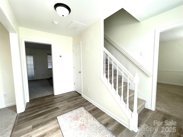 stairs featuring baseboards and wood finished floors