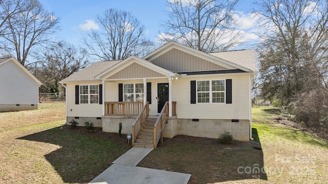 bungalow-style home featuring crawl space, a shingled roof, and a front yard