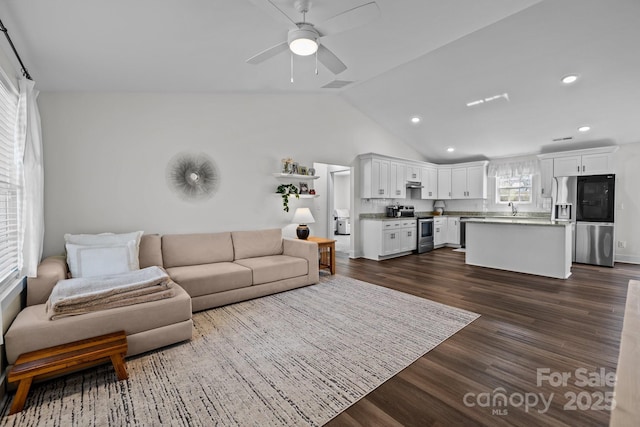 living area featuring dark wood-style floors, lofted ceiling, recessed lighting, visible vents, and a ceiling fan