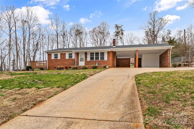 single story home with a carport, driveway, a chimney, and brick siding