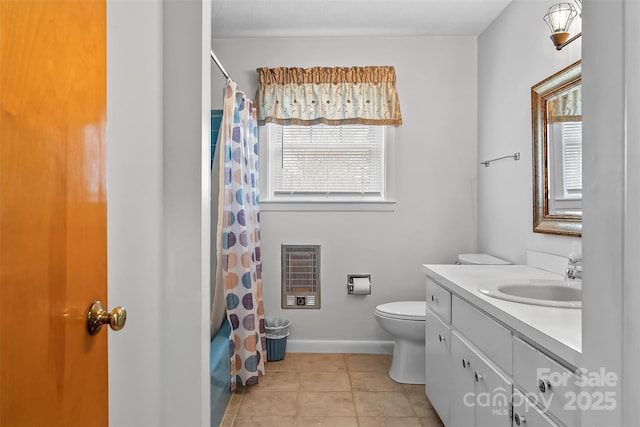 full bathroom featuring toilet, heating unit, tile patterned flooring, baseboards, and vanity