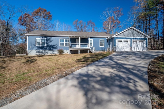 view of front of property featuring driveway, an attached garage, covered porch, crawl space, and a front yard