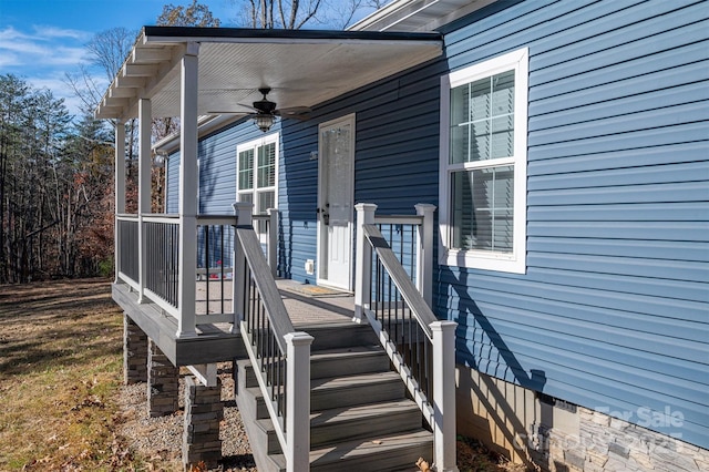 view of exterior entry with a ceiling fan