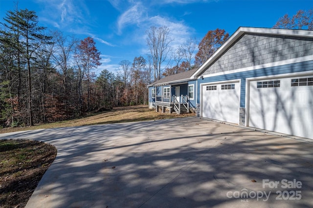 view of side of property with concrete driveway