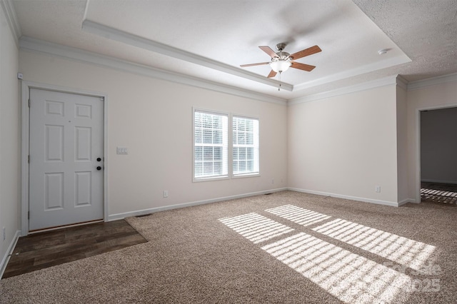 interior space featuring carpet floors, baseboards, and a tray ceiling