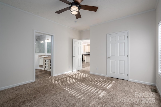 unfurnished bedroom with carpet floors, ornamental molding, connected bathroom, and baseboards