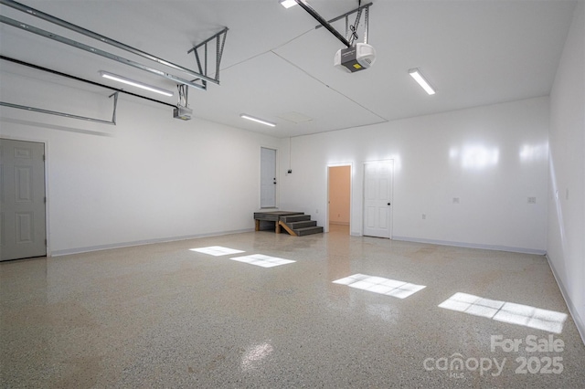 garage featuring baseboards and a garage door opener