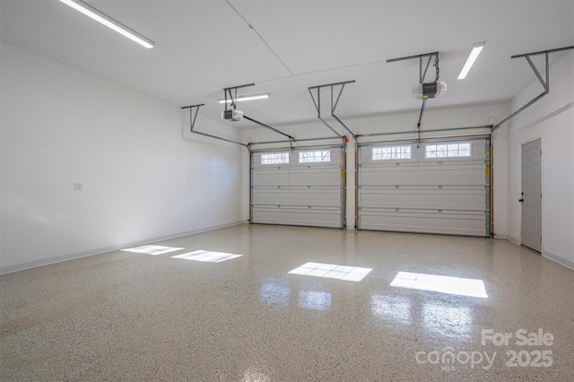 garage with baseboards and a garage door opener