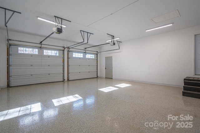 garage with baseboards and a garage door opener