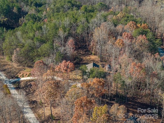 birds eye view of property with a view of trees