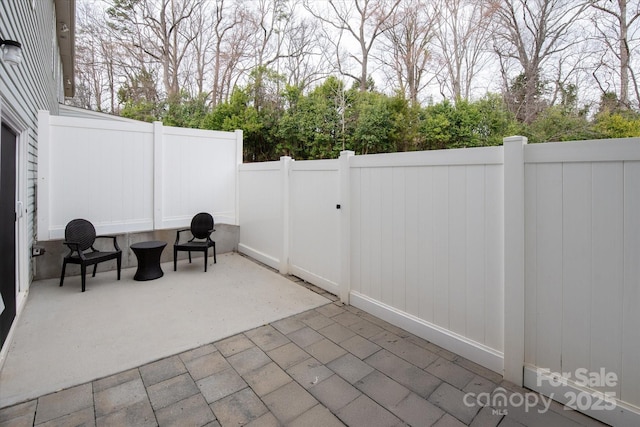 view of patio / terrace featuring fence