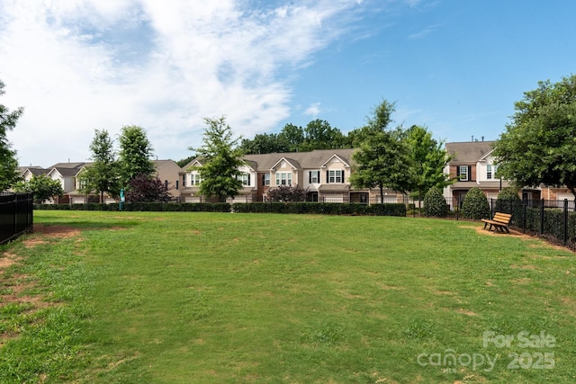 view of yard featuring a residential view and fence