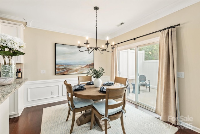 dining room with dark wood-style floors, a notable chandelier, visible vents, and ornamental molding