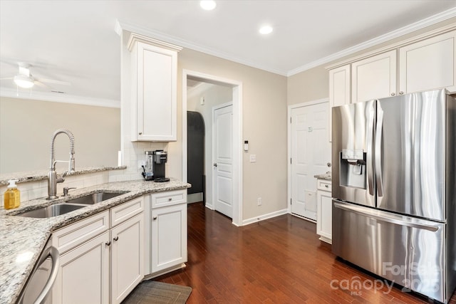 kitchen featuring a sink, stainless steel appliances, backsplash, and crown molding