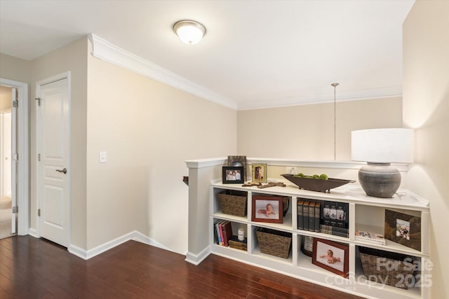 corridor with hardwood / wood-style floors, crown molding, and baseboards