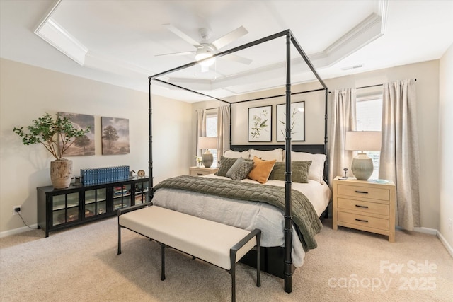 bedroom with baseboards, visible vents, ornamental molding, a raised ceiling, and light colored carpet