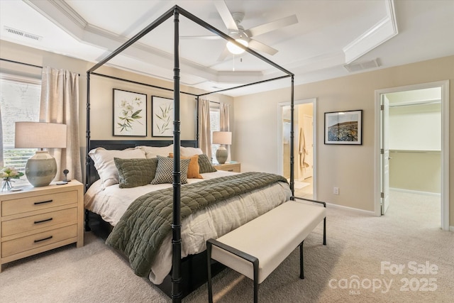 bedroom featuring visible vents, a raised ceiling, light colored carpet, and ornamental molding