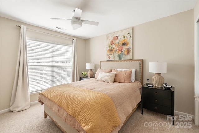 carpeted bedroom with visible vents, ceiling fan, and baseboards