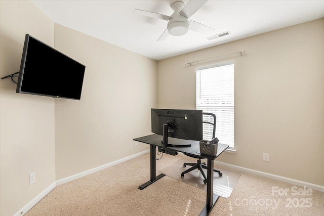 carpeted office featuring visible vents, baseboards, and a ceiling fan