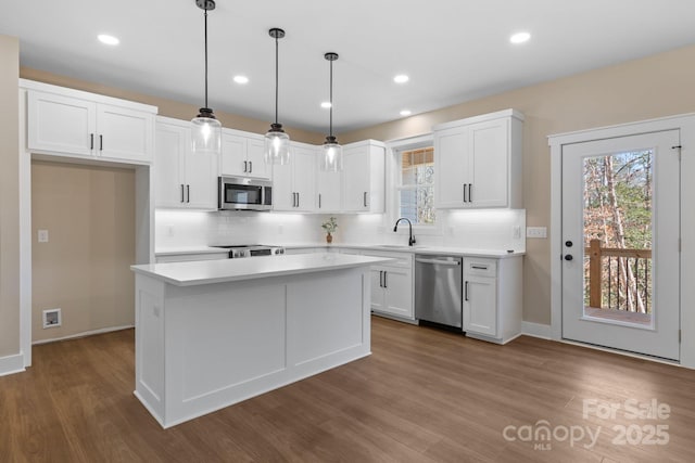 kitchen featuring white cabinetry, light countertops, plenty of natural light, and stainless steel appliances