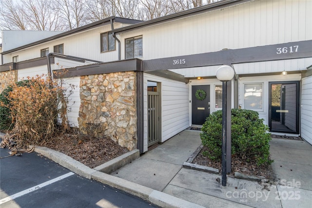 doorway to property featuring stone siding