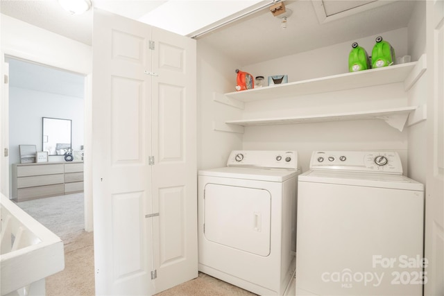 clothes washing area featuring laundry area, light colored carpet, and separate washer and dryer