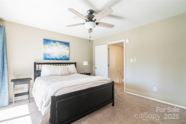 bedroom with light carpet, ceiling fan, and baseboards