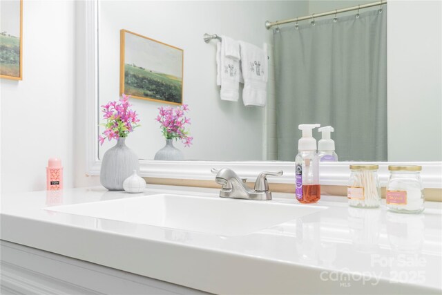 bathroom featuring curtained shower and vanity