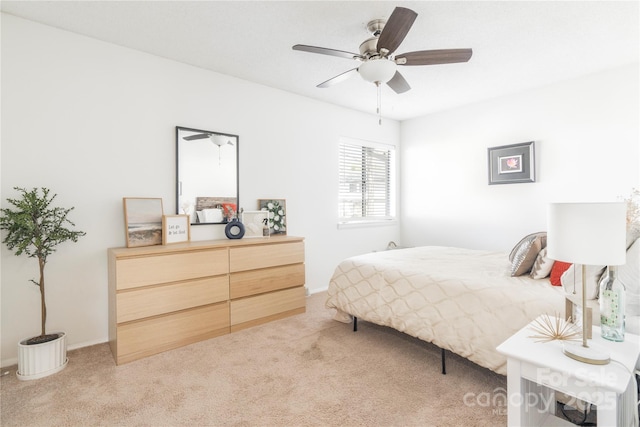 bedroom featuring baseboards, a ceiling fan, and light colored carpet