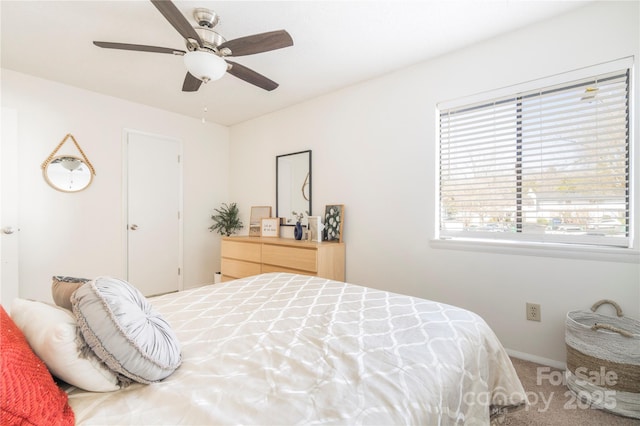 bedroom featuring a ceiling fan, carpet, and baseboards