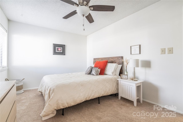 bedroom featuring light carpet, a textured ceiling, a ceiling fan, and baseboards