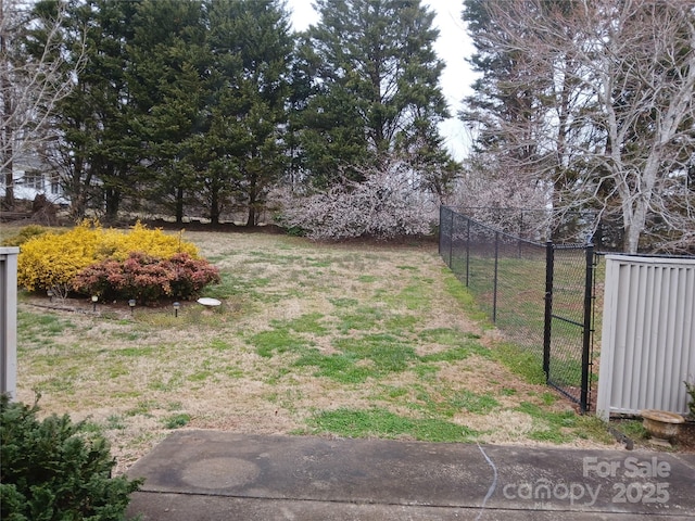 view of yard featuring fence and a gate