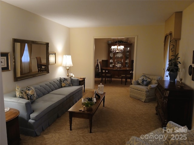 living area with carpet and an inviting chandelier