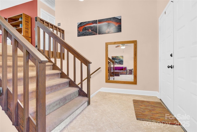 staircase with tile patterned flooring and baseboards