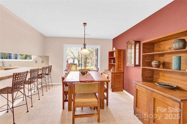 dining room featuring baseboards and light tile patterned floors