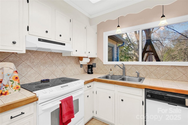 kitchen featuring white appliances, white cabinets, a sink, and under cabinet range hood