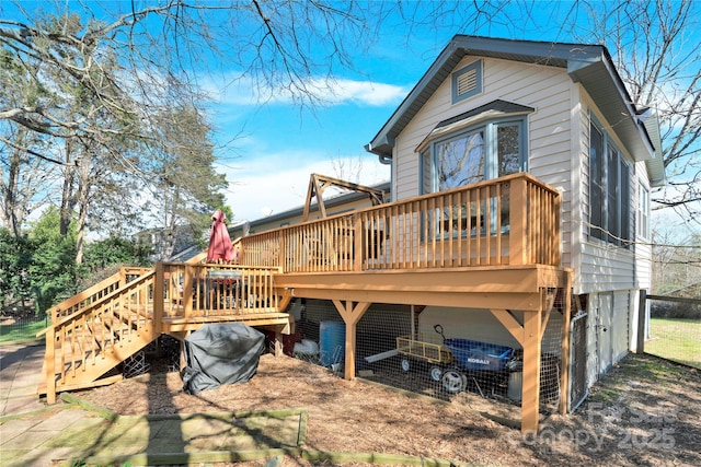 rear view of property featuring a deck