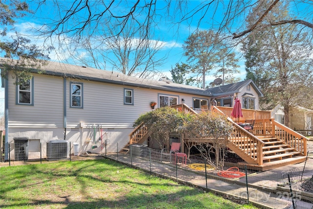 rear view of house with a yard, fence, a deck, cooling unit, and stairs